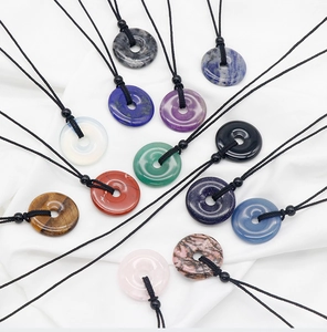 Various 30mm natural gemstone donut pendants including amethyst and tiger eye with cords