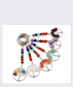 Detailed view of handmade chakra tree of life keychains with natural crystal stones