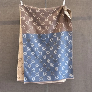 Detail of three-color contrast scarf with four-leaf clover pattern and fringe edges