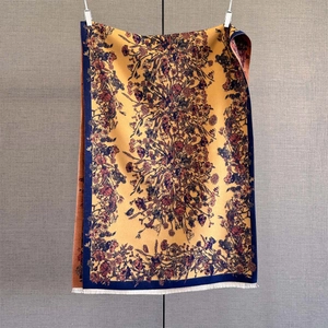 Detail of vintage floral print scarf in yellow and blue with soft tassel fringe edges