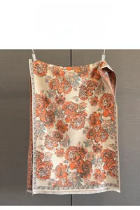 Detail showing vintage peony jacquard texture and white fringe tassels on the scarf
