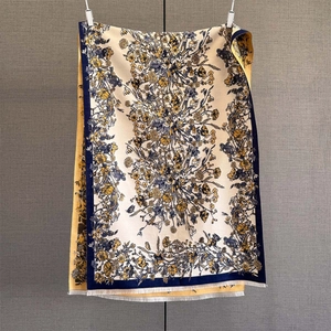 Detailed close-up of cashmere-like scarf with paisley jacquard and white fringe trim