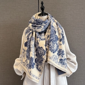 Close-up of vintage peony jacquard scarf with delicate fringe edges and floral patterns