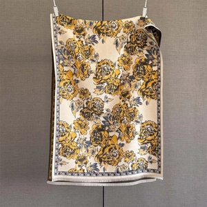 Detail of vintage peony jacquard scarf with blue floral patterns and white fringe edge