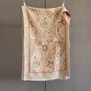 Detail of paisley pashmina shawl showing intricate weave patterns and soft fringe edges