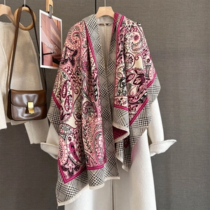 Close-up of paisley jacquard scarf with houndstooth pattern and vibrant pink edges