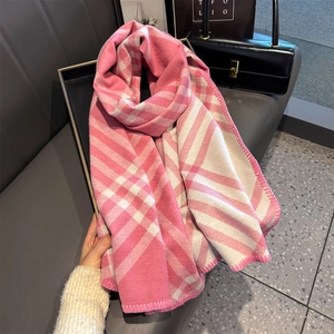 Close-up of pink and white checkered scarf featuring high-quality overlock stitched edges
