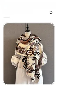 Detailed view of vintage floral cashmere scarf with delicate tassel edges on white coat