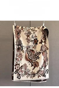 Close-up of vintage floral and butterfly jacquard scarf with fine tassel fringe detail