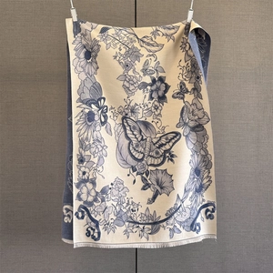 Detailed view of paisley cashmere scarf with delicate fringe and floral butterfly print