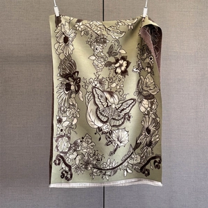 Detail of vintage floral butterfly print on sage green scarf with fringe tassels