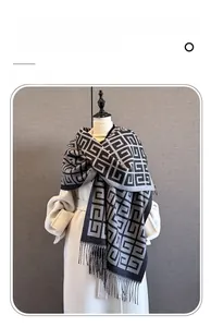 Detail of imitation cashmere scarf with interlocking geometric pattern and fringe trim
