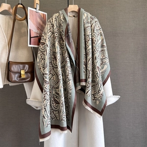 Autumn winter paisley cashmere-like shawl with fringe over a white coat for women