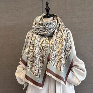 Detail of soft paisley pattern cashmere-feel scarf with fine fringe edges and tassels