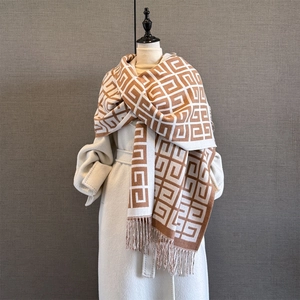 Detail of classic jacquard geometric pattern and tassel fringe on warm pashmina scarf
