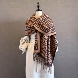 Close-up of interlocking geometric pattern on thick cashmere-feel scarf with fringe