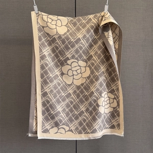 Gros plan du motif de camélia élégant sur une écharpe pashmina à rayures et franges