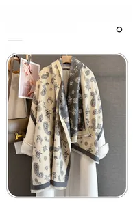 Detail of paisley jacquard pattern and tassel edges on imitation cashmere shawl