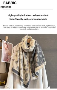 Close-up of beige and grey paisley jacquard scarf with soft fringe edges and premium texture