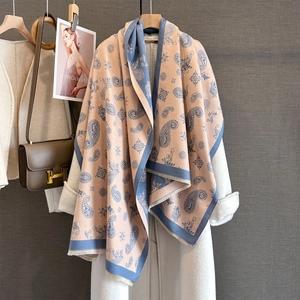 Detail of paisley pattern jacquard scarf with fringe edges and premium texture