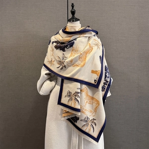 Close-up of zebra and palm tree prints on cashmere shawl with tassel trim details