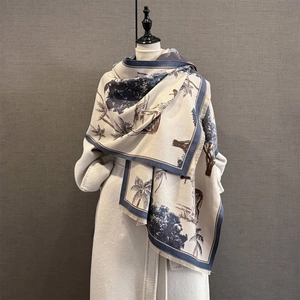Detailed view of large cashmere-feel shawl with vintage nature print and blue fringe edges