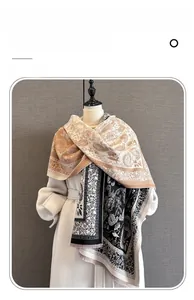 Detail of paisley pattern imitation cashmere scarf with soft fringes and floral textures