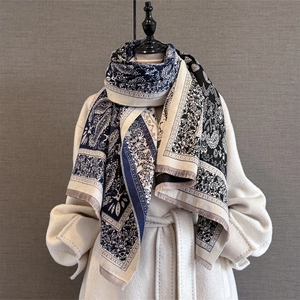 Close-up of vintage paisley jacquard scarf with contrast colors and fringe detail