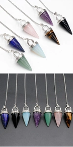 Detailed macro view of assorted natural crystal cone pendulums with silver metal chains