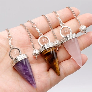 Detailed close-up of amethyst, tiger eye, and rose quartz conical crystal pendulums