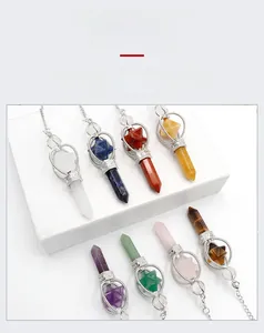 Close-up of natural hexagonal crystal pendants with silver hollow hexagram star caps
