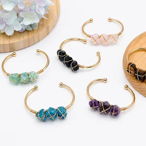 Detailed view of vintage gold wire wrapped bangles with assorted natural gemstones