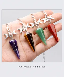 Detail of natural crystal pendulums with silver moon and star charms for meditation