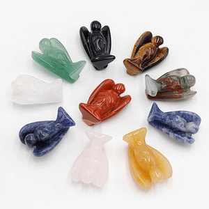 Detailed arrangement of miniature angel figurines carved from natural gemstones and crystals