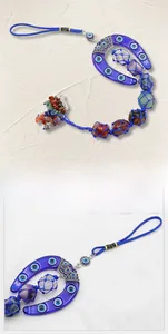 Detail of blue Evil Eye horseshoe car charm with colorful chakra raw crystals and tassels