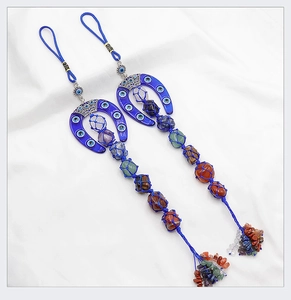 Macro detail of natural chakra stones and blue Nazar evil eye horseshoe wall ornament