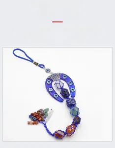 Detailed close-up of handmade evil eye horseshoe wall decor with colorful raw crystals