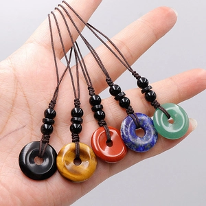 Set of five natural crystal stone donut keychains in various healing gemstone colors