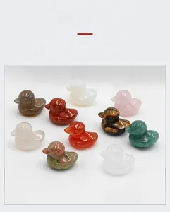 Macro detail of hand-carved duck figurines in various natural polished crystals and stones