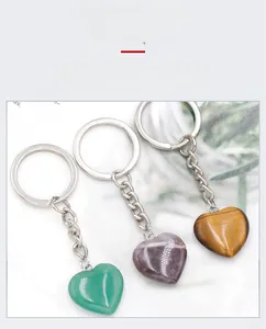 Detailed close-up of heart-shaped natural crystal keychains in various colorful gemstones