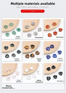 Nine variations of heart-shaped natural stone pendants displayed on wooden trays
