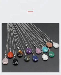 Detailed view of faceted teardrop natural crystal pendants with polished stone textures