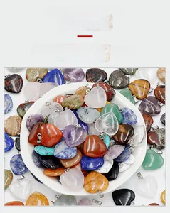 Assorted 20mm heart-shaped natural crystal pendants with metallic bails in a white bowl