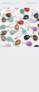 Macro shot of faceted gemstone teardrop pendants in amethyst, tiger eye, and rose quartz
