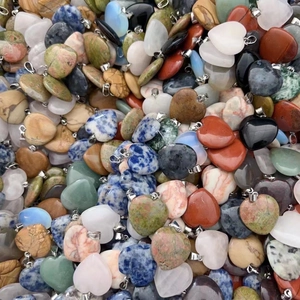 Macro shot of assorted heart-shaped natural crystal pendants with silver metal clasps