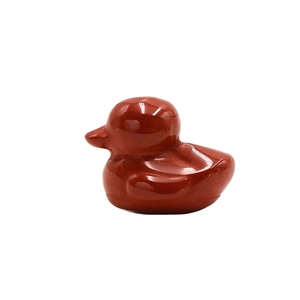 Polished Red Jasper carved duck figurine made from natural crystal stone on white background