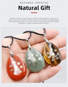 Détail de pendentifs en pierre naturelle en forme de goutte avec gravures de yoga