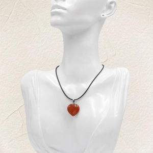 20mm Red Agate Heart Pendant Necklace with a sleek black cord on a jewelry bust display
