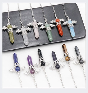 Detailed view of hexagonal crystal pendants with silver angel wings and assorted natural stones