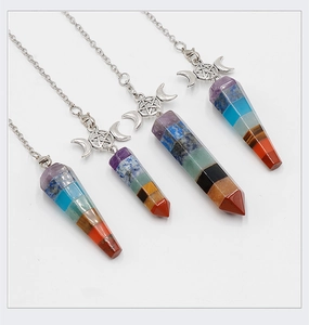 Macro view of four hexagonal cone 7 chakra crystal pendants with triple moon symbols